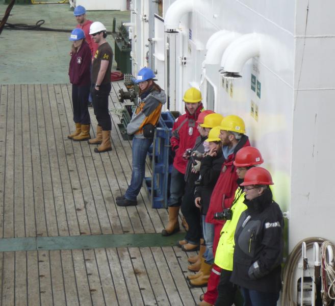 Marine scientists standing on the deck of a research ship